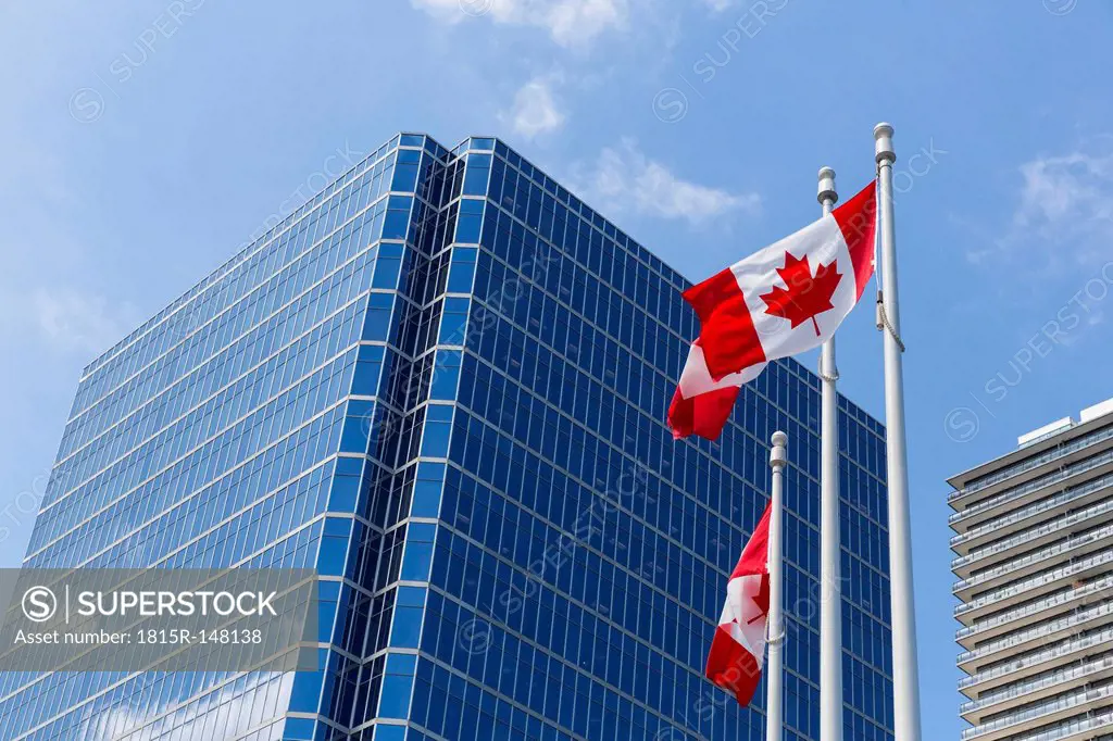 Canada, British Columbia, Vancouver, Canadian flags in front of skyscrapers