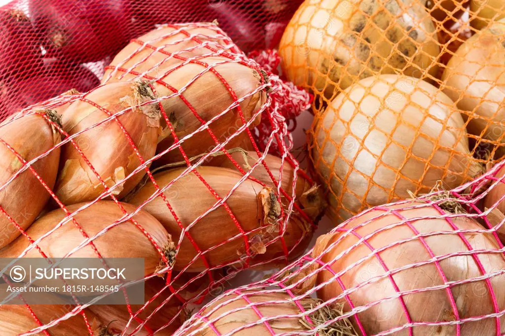 Studio, variety of onions in a net