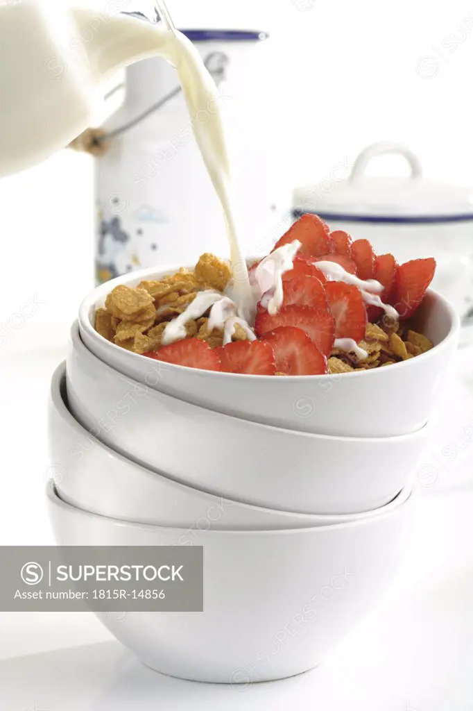 Cornflakes and strawberries in bowl, close-up