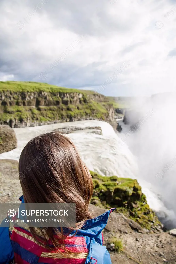Iceland, female tourist at the famous Gullfoss Waterfall
