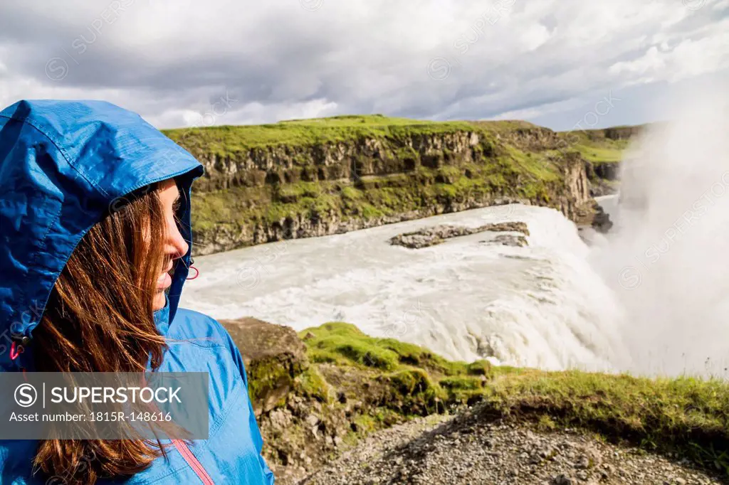 Iceland, female tourist at the famous Gullfoss Waterfall