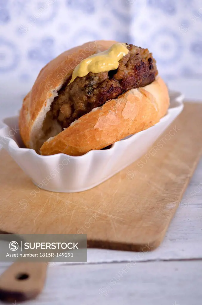 Burger with bread roll and mustard