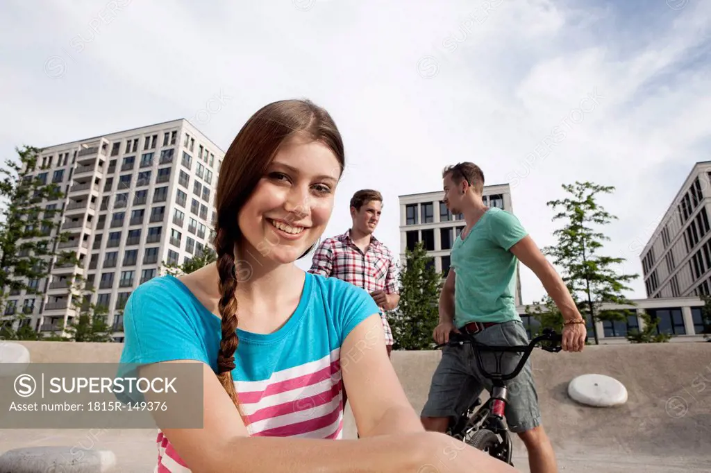 Germany, Bavaria, Munich, Smiling young woman outdoors