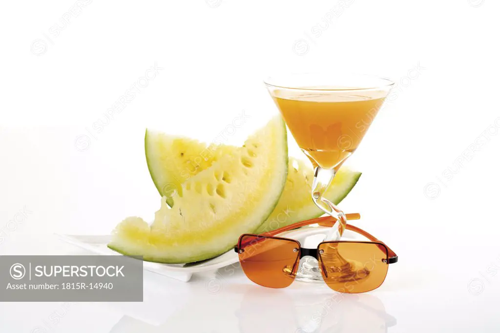 Sliced melon sunglasses and drink, close-up