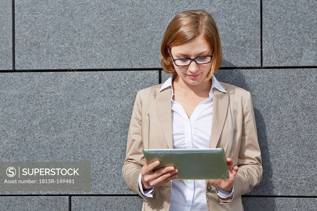 Germany, Businesswoman using digital tablet