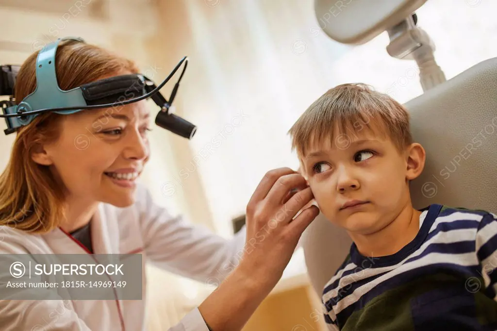 ENT physician examining ear of a boy