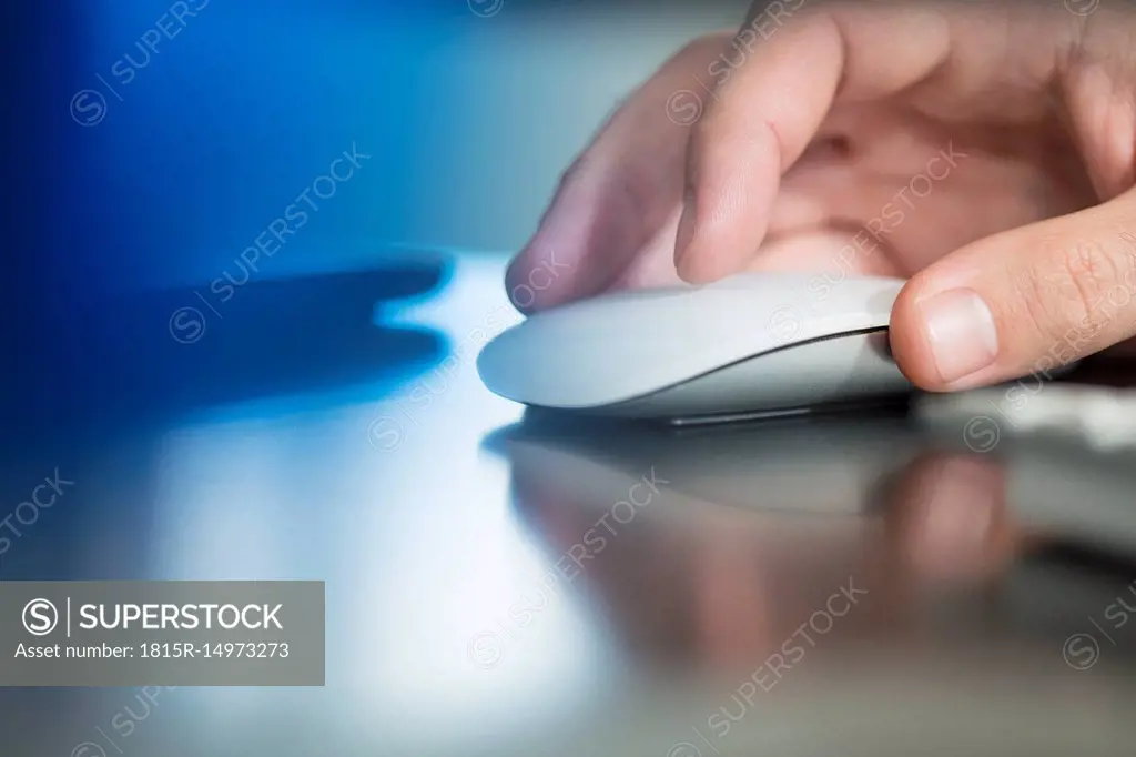 Man's hand using computer mouse