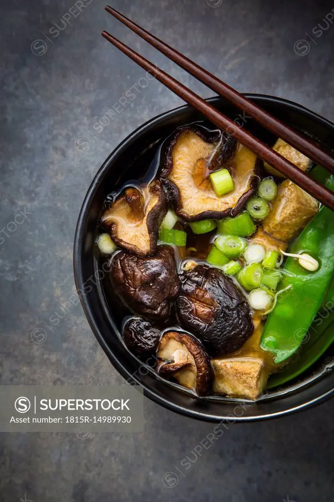 Japanese miso soup with sugar peas, shitake mushrooms, tofu and mung sprouts