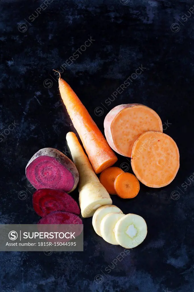 Sliced root vegetables on dark ground