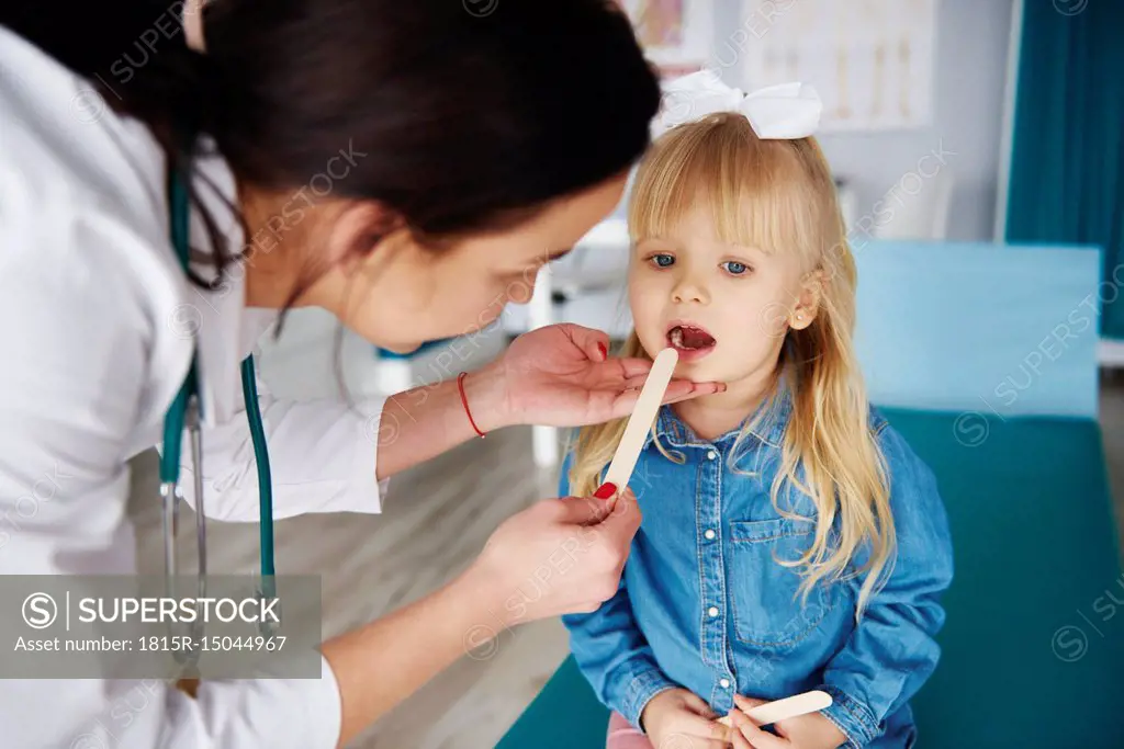 Doctor examining girl in medical practice
