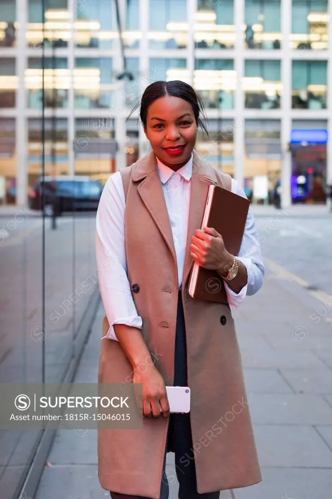 Portrait of smiling businesswoman with cell phone