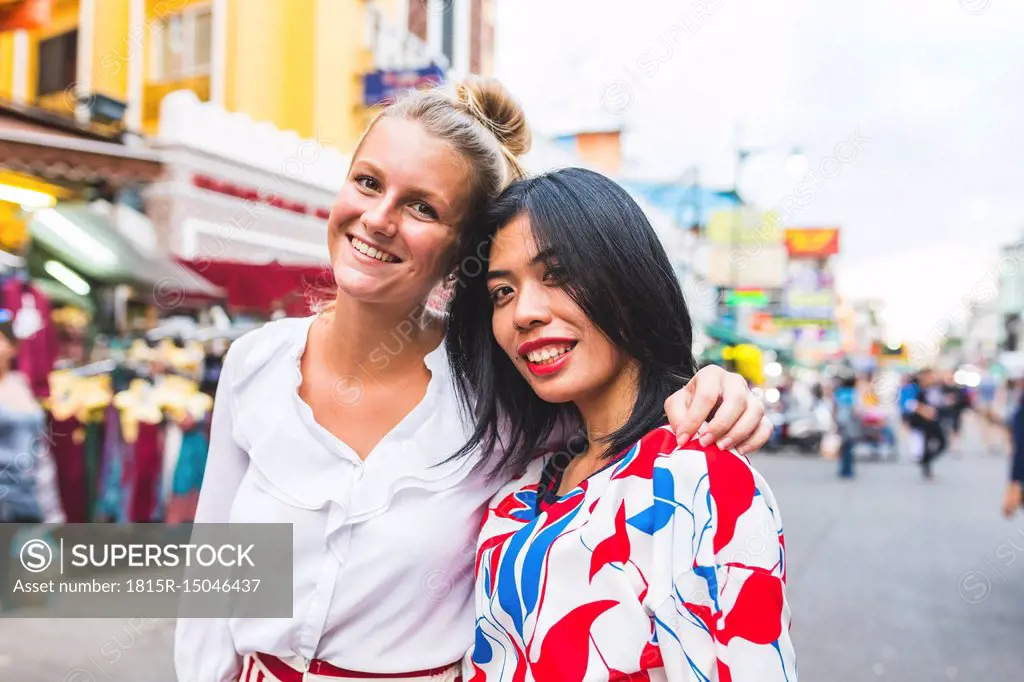 Thailand, Bangkok, Khao San Road, portrait of two happy friends