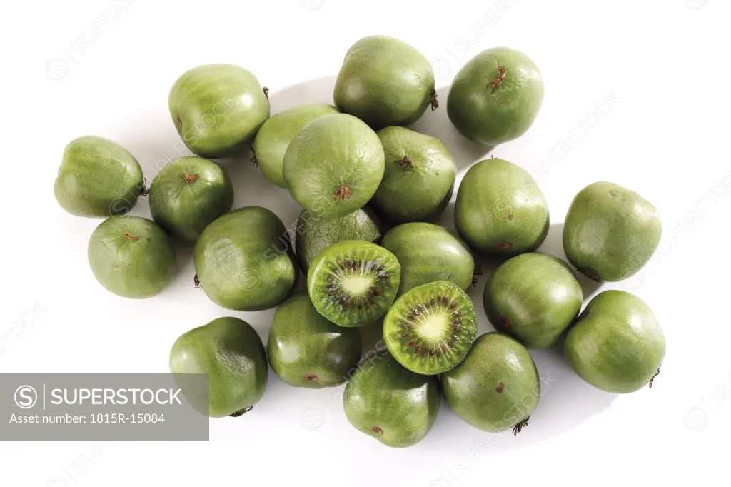 Whole and halved kiwi fruits, close-up