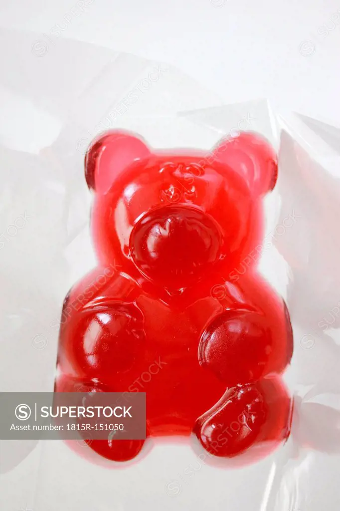 Big red jellybaby in cellophane, studio shot