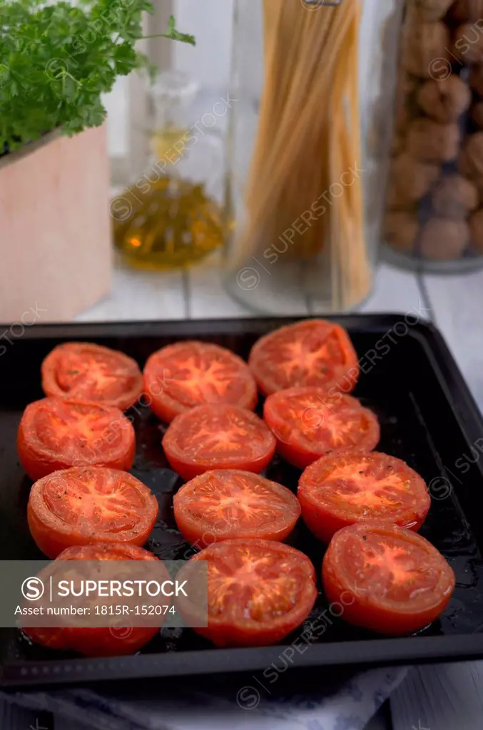 Grilled tomatoes on baking plate, studio shot