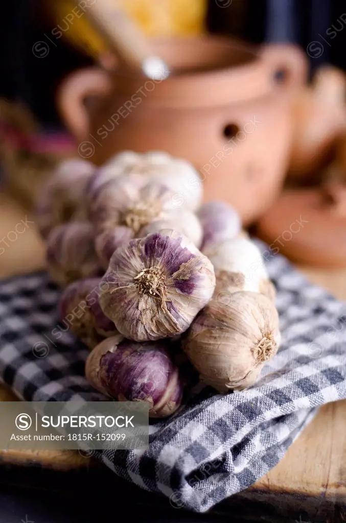 French garlic braid and dish towel on wooden chopping board