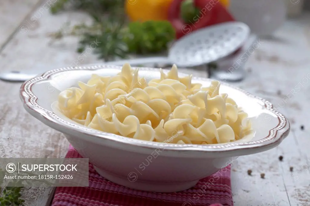 Freshly cooked fusilli in bowl, close up