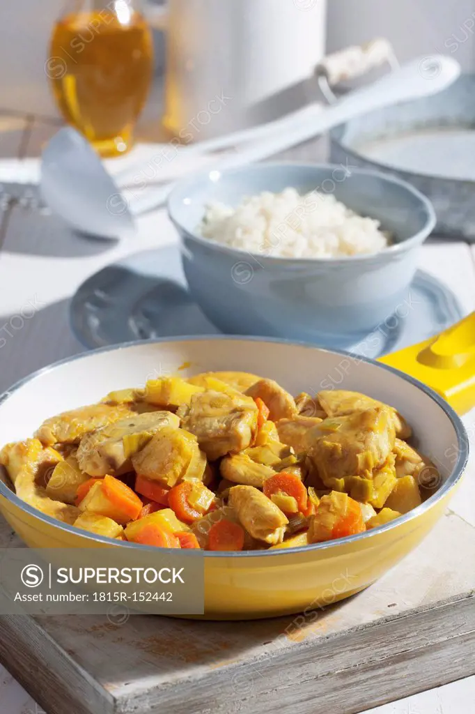 Chicken curry in yellow pan, close up