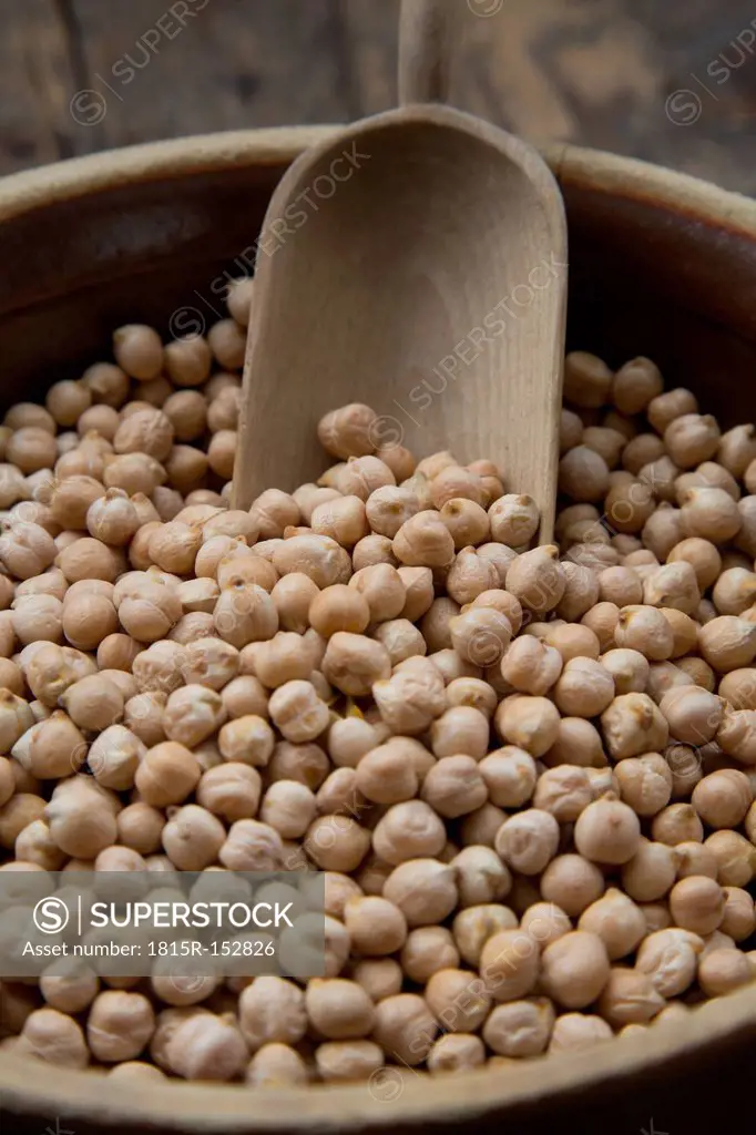 Chickpeas in pot on wooden table