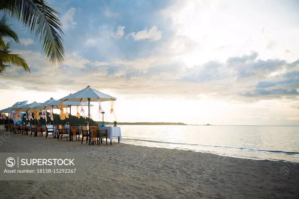 Thailand, Khao Lak, rows of laid tables, chairs and beach umbrellas at seaside