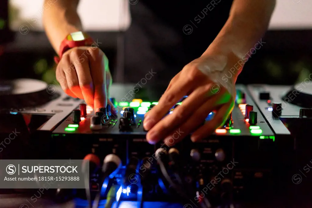 DJ working on mixing board