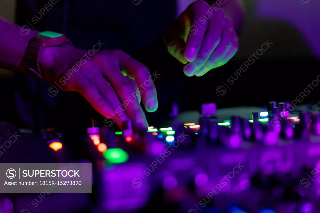 DJ working on mixing board