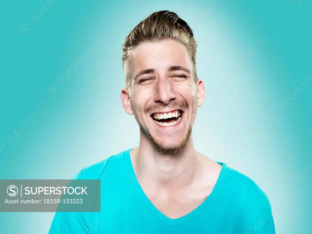 Portrait of laughing young man, studio shot
