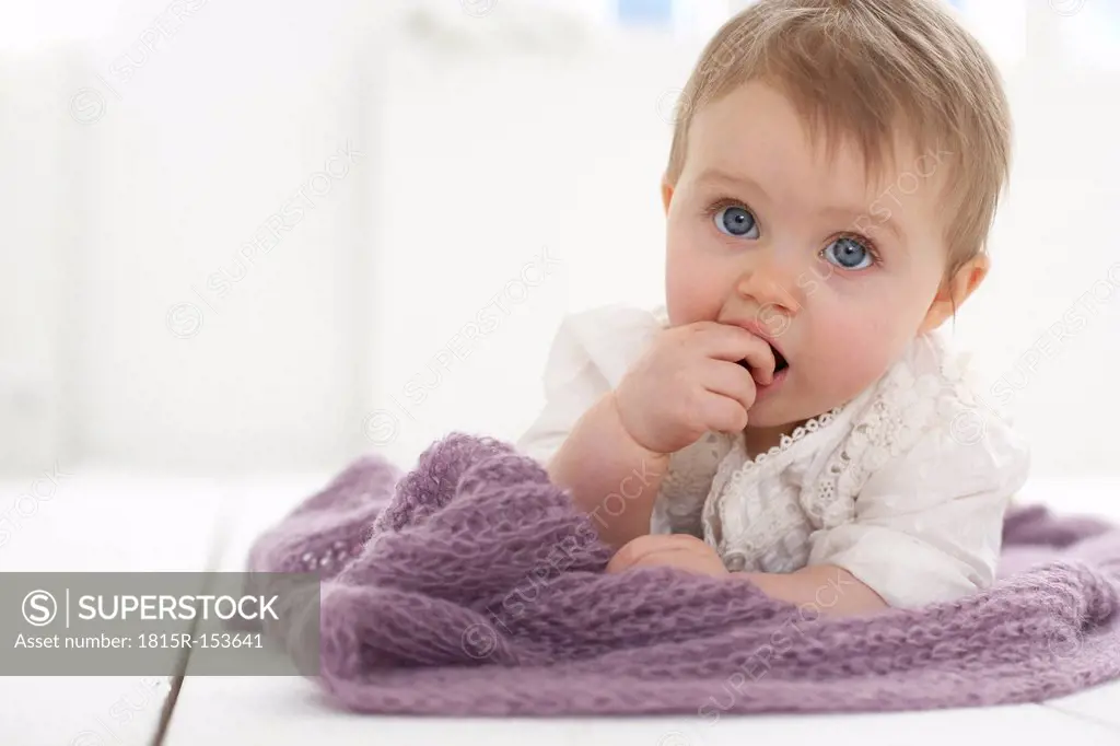 Baby girl with finger in mouth
