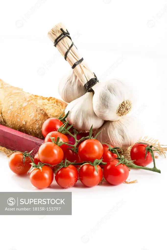 Baguette with tomatoes and garlic on tray