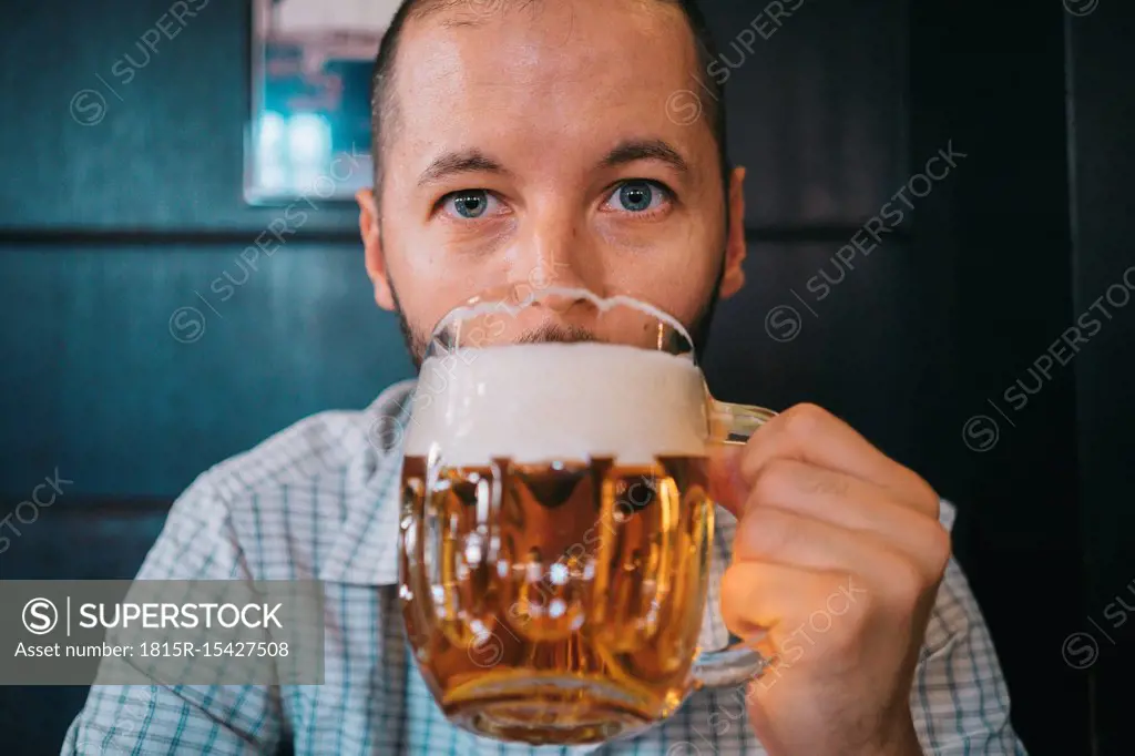 Czechia, portrait of man drinking beer in a pub