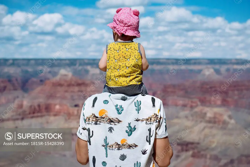 USA, Arizona, Grand Canyon National Park, father and baby girl enjoying the view, rear view