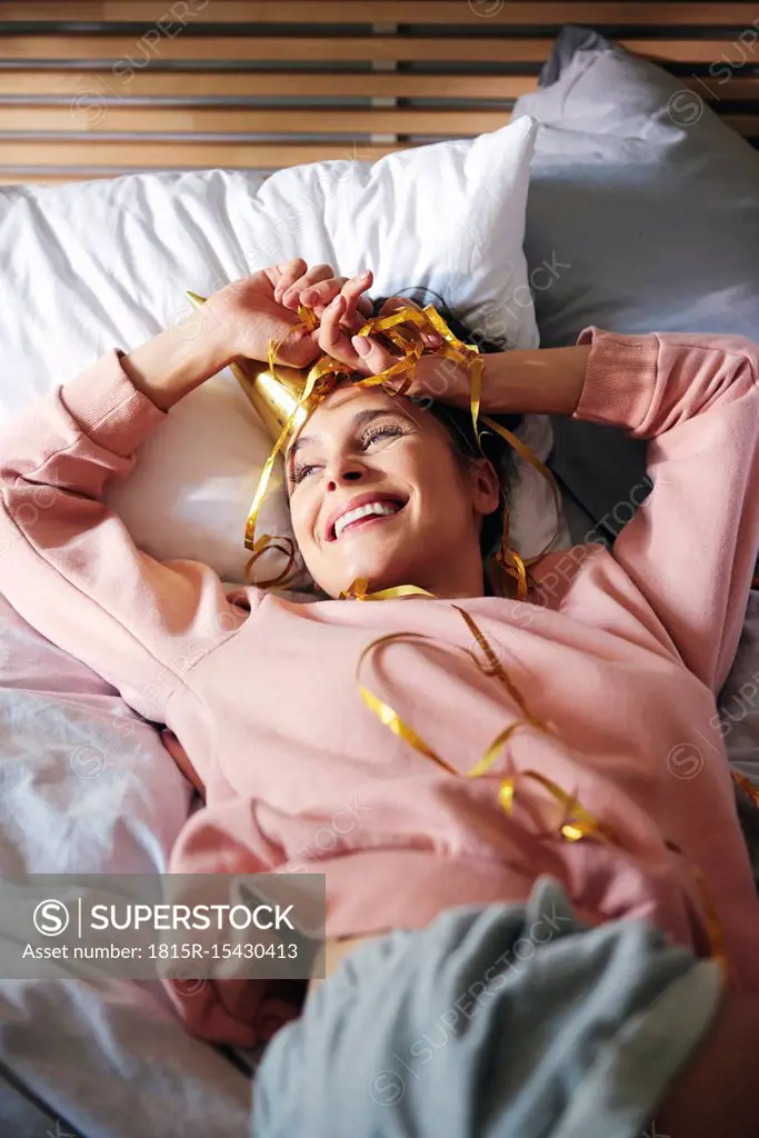 Woman resting after birthday party on bed