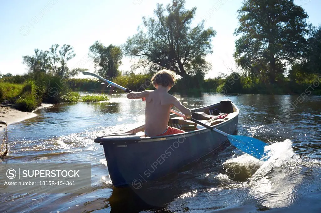 Germany, Brandenburg, Boy paddeling on Spree river