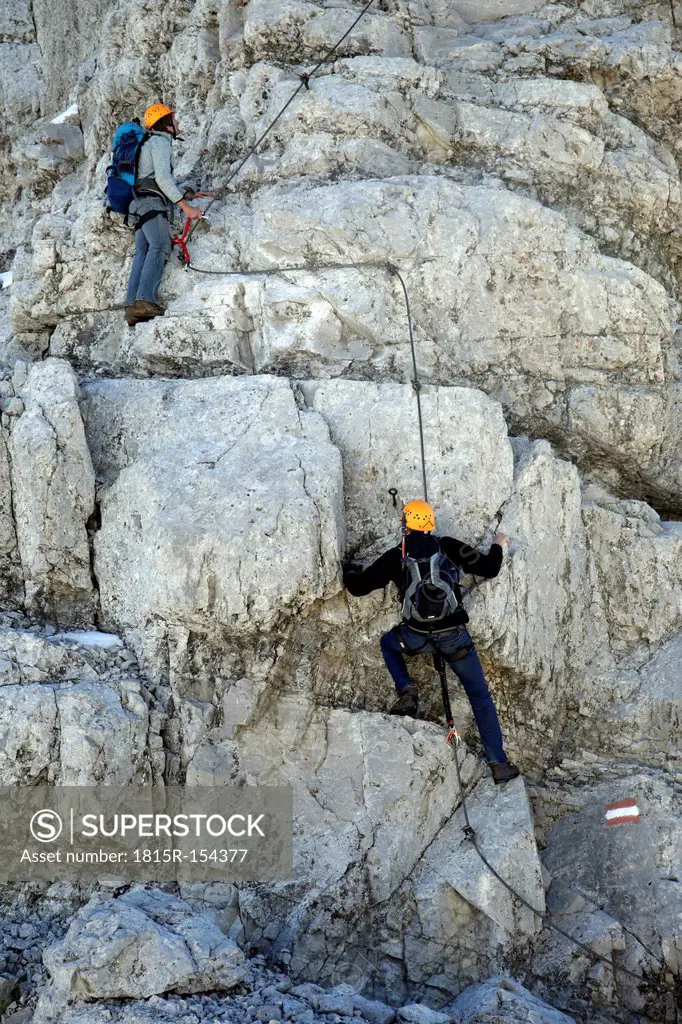 Austria, Tyrol, Karwendel mountains, Mountaineers climbing rockface