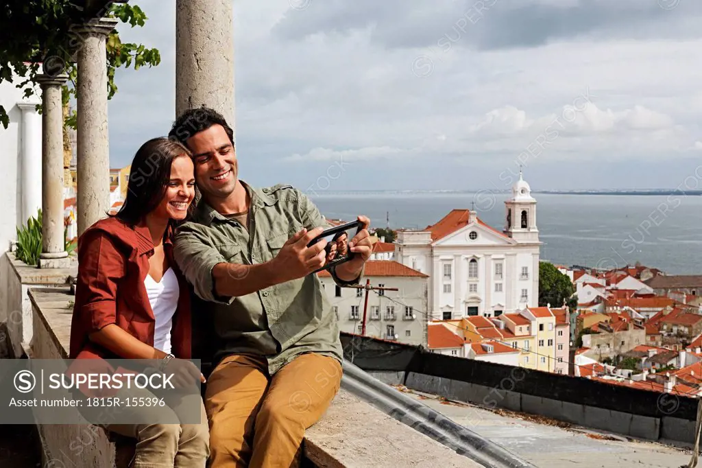 Portugal, Lisboa, Alfama, Miradouro de Santa Luzia, young couple photographing themself
