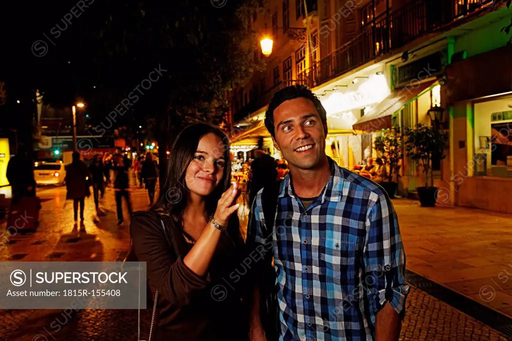 Portugal, Lisboa, Baixa, Rossio, Praca Dom Pedro IV, young couple on the way by night