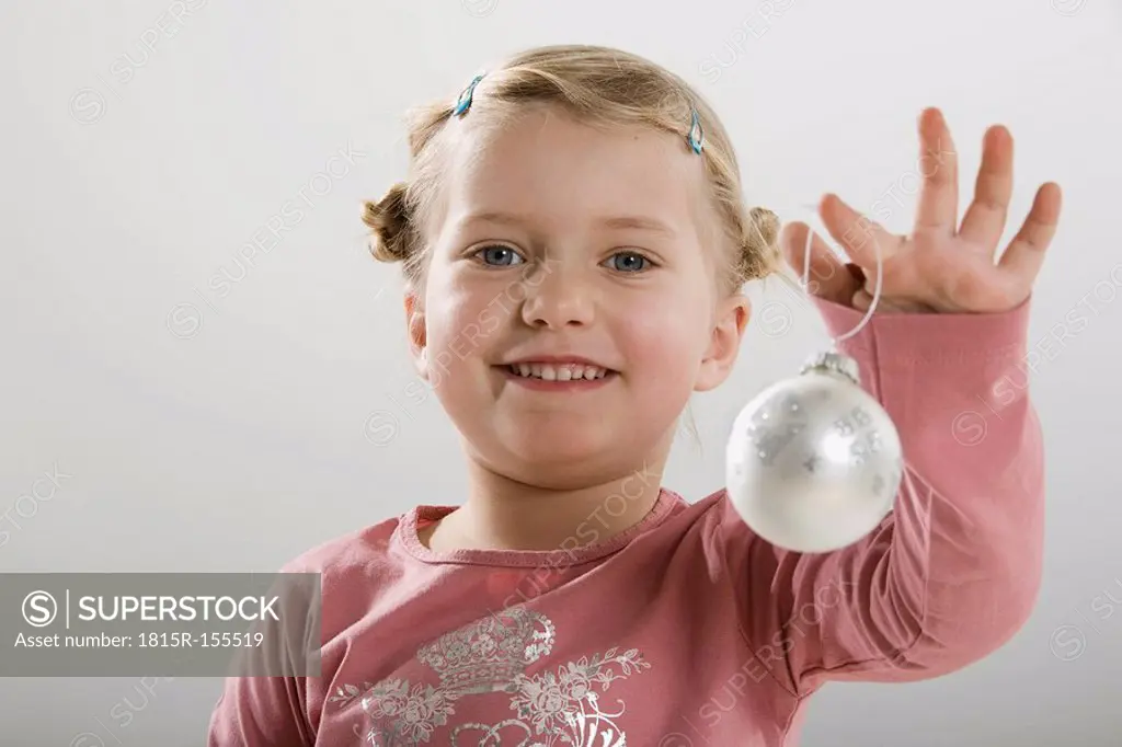 Little girl 3_4 holding Christmas bauble