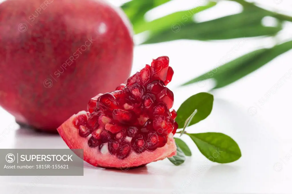 Piece of pomegranate with seeds, close up