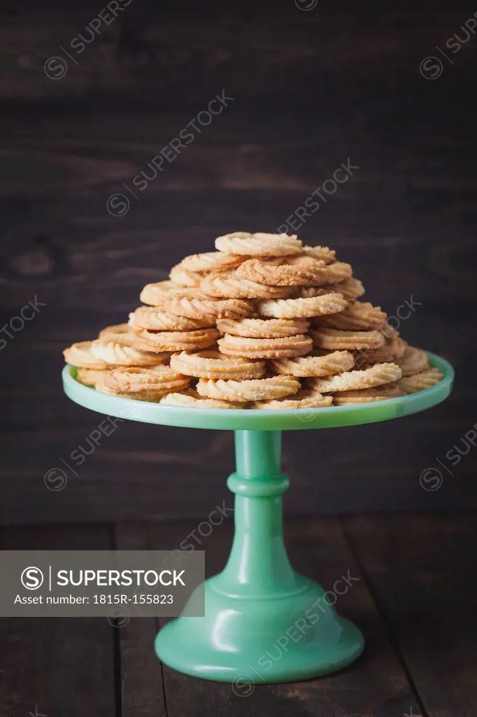 Traditional spritz cookies on green cake plate