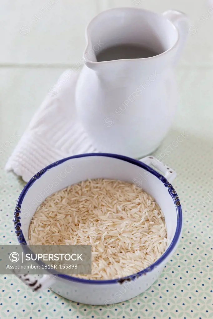 Basmati rice in pot and pitcher of water
