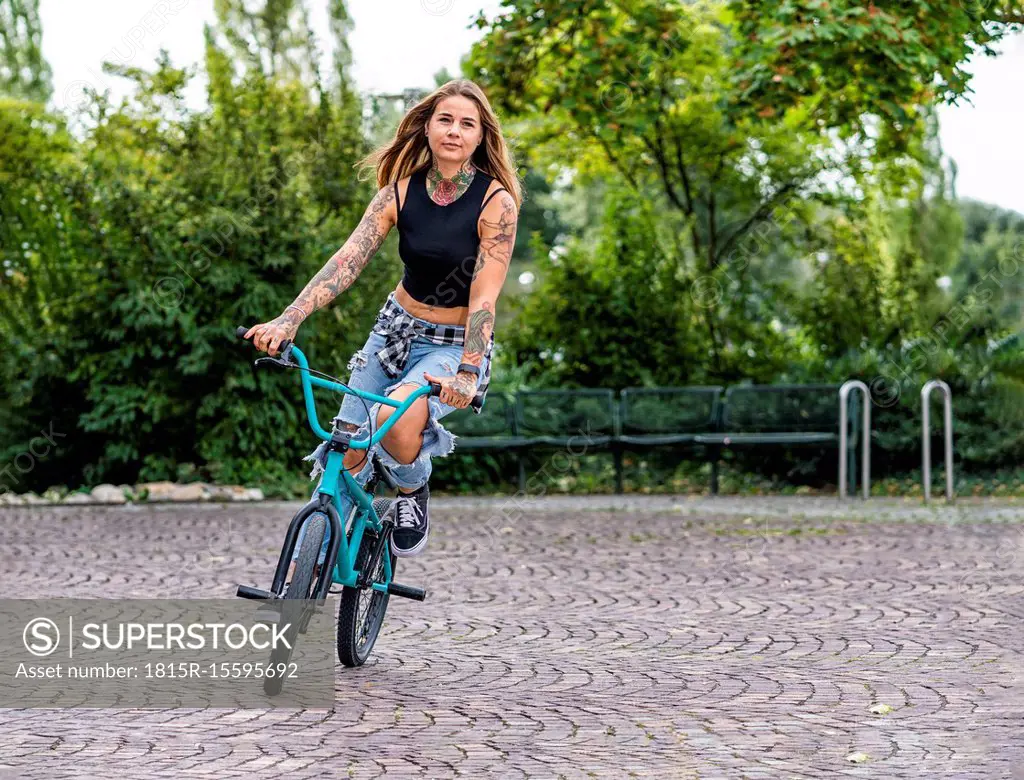 Young woman riding her BMX bike