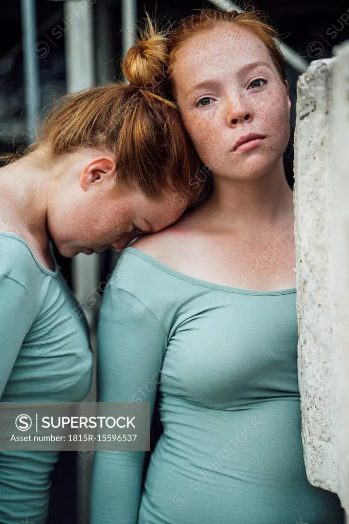 Redheaded twins, head supported
