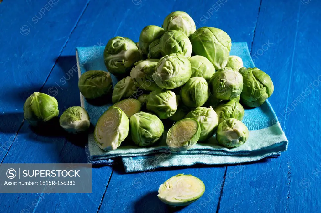 Brussel sprout on kitchen towel, blue wooden table