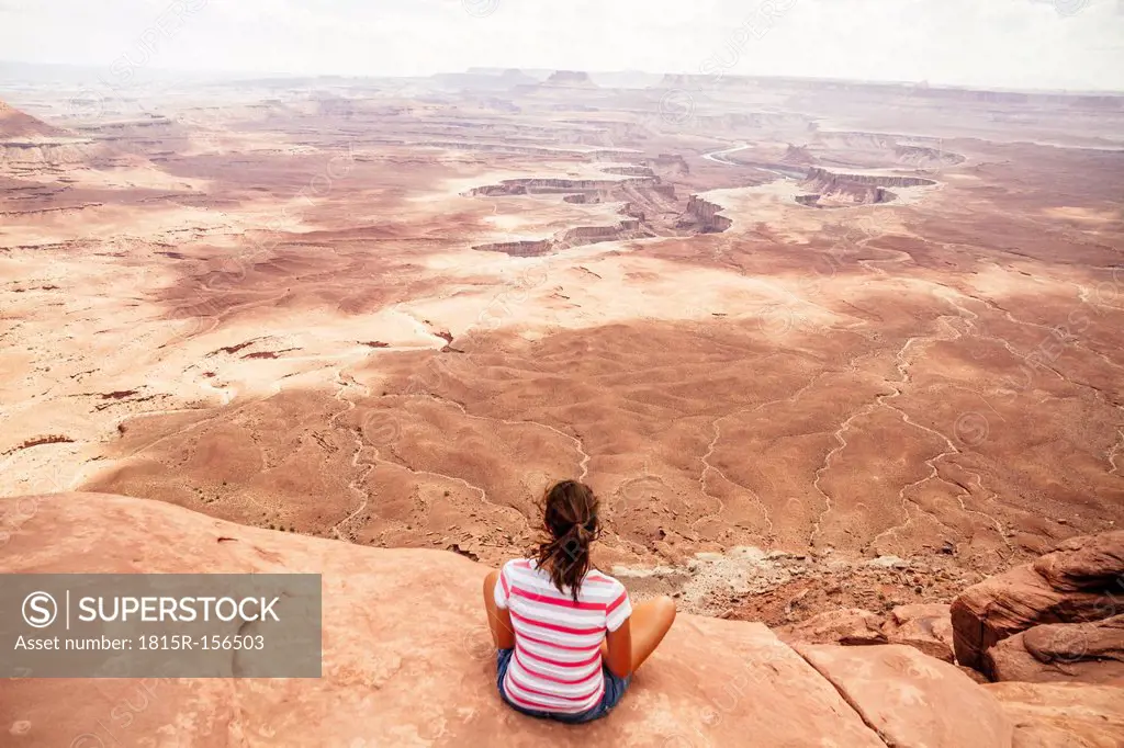 USA, Utah, Young woman looking over Canyonlands National Park