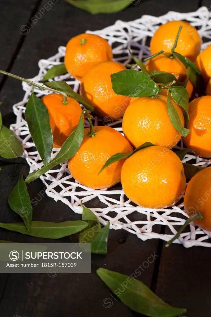 Tangerines on doily and wooden table