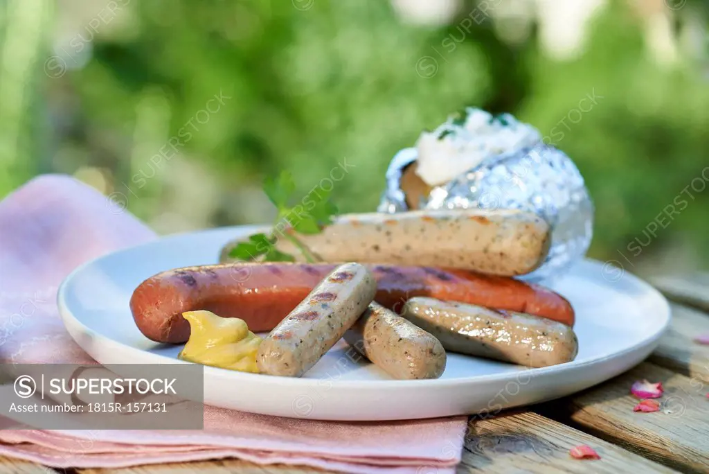 Grilled sausages and mustard on plate