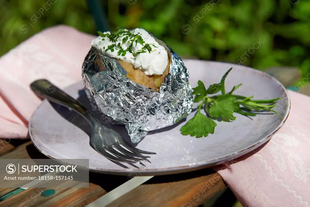 Baked potatoe and fork on plate