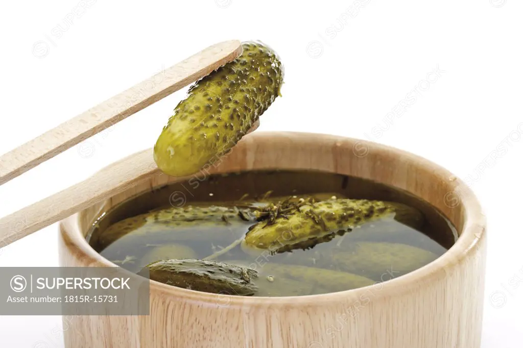 Pickled gherkins in wooden vessel, close-up