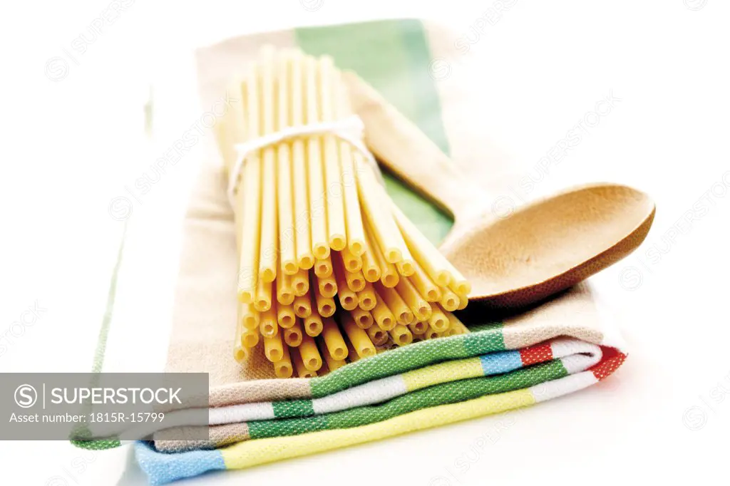 Bunch of macaroni on dish cloth, close-up