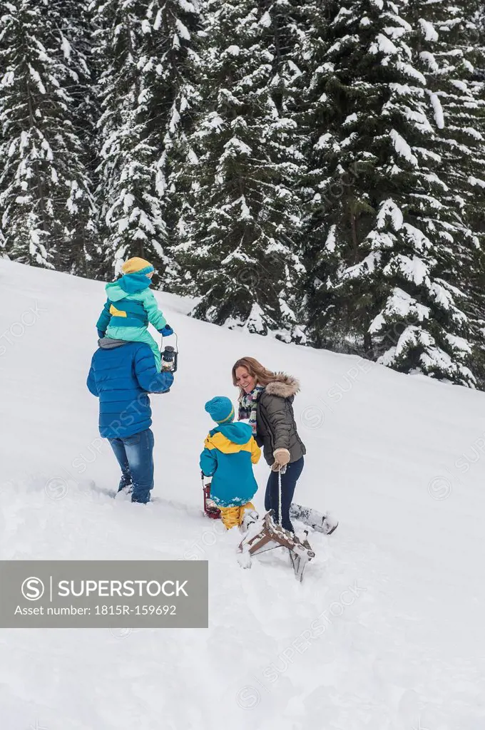 Austria, Salzburg Country, Altenmarkt-Zauchensee, Family walking in snow, pulling sledge